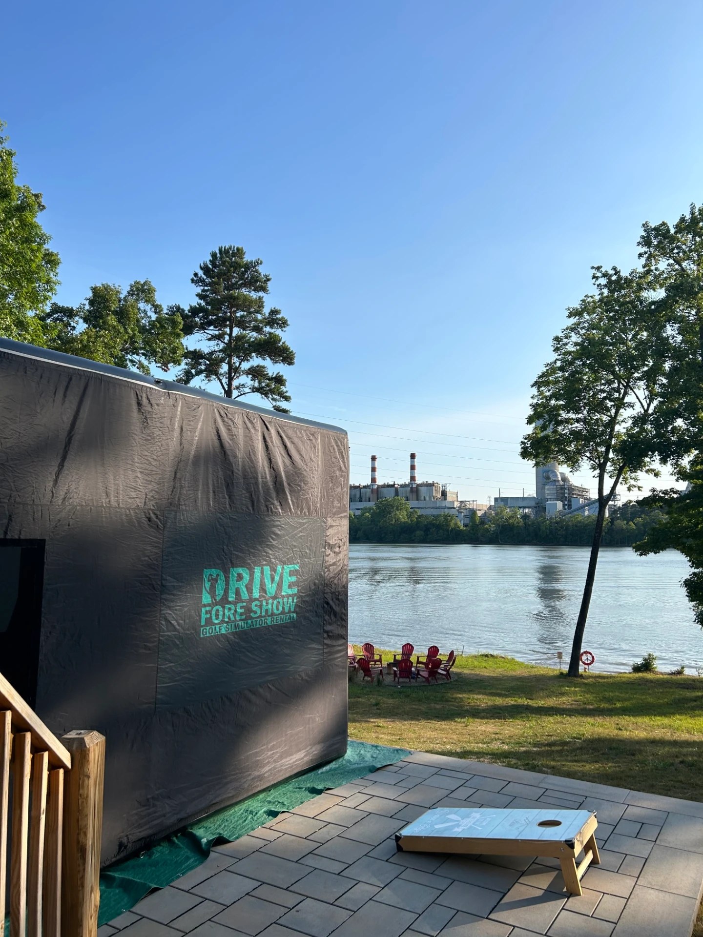 Drive Fore Show portable golf simulator set up by the water at an outdoor event